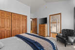 This inviting bedroom features a cozy bed adorned with a stylish blue and beige throw blanket.