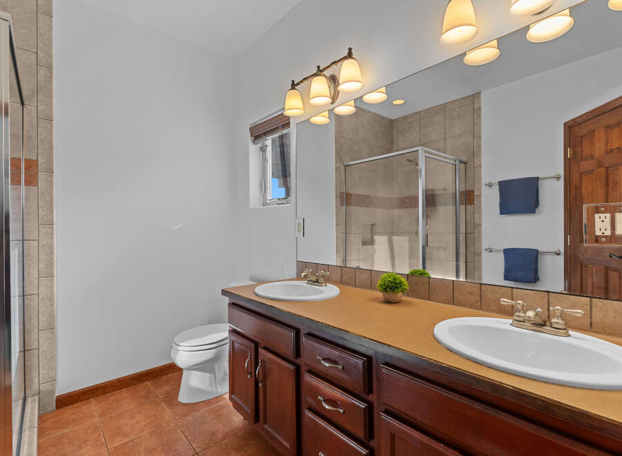 This stunning bathroom boasts a double vanity with ample counter space, perfect for getting ready in the morning.