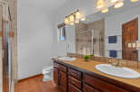 This stunning bathroom boasts a double vanity with ample counter space, perfect for getting ready in the morning.