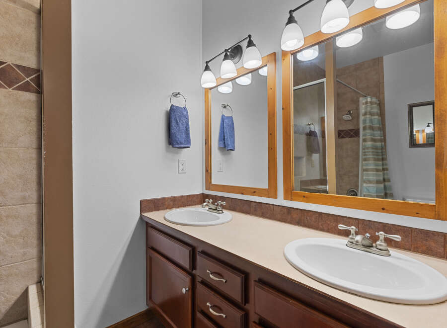 This beautiful bathroom features a double vanity with ample counter space, perfect for getting ready in the morning.