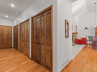 Step into this inviting home and discover a hallway with beautiful hardwood floors and ample storage space.