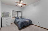 This cozy bedroom features a comfortable bed with a stylish blue comforter and a decorative throw blanket.