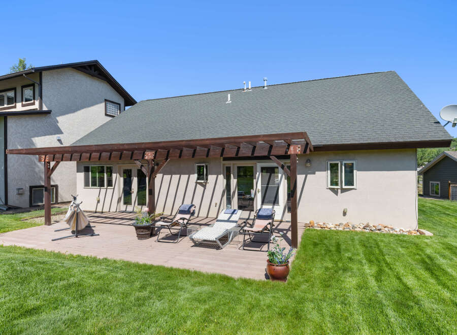Enjoy outdoor living at its finest with this stunning property! Featuring a spacious deck, perfect for entertaining or relaxing, and a lush green lawn, this home offers a serene escape.