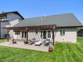 Enjoy outdoor living at its finest with this stunning property! Featuring a spacious deck, perfect for entertaining or relaxing, and a lush green lawn, this home offers a serene escape.