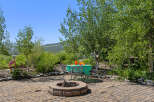 Enjoy outdoor living at its finest with this charming property! Featuring a cozy fire pit, perfect for gatherings, and a shaded dining area, this space is ideal for relaxation and entertainment.