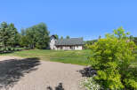 Discover the charm of this stunning property, featuring a spacious lawn and a beautifully designed house.