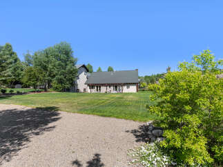 Discover the charm of this stunning property, featuring a spacious lawn and a beautifully designed house.