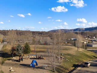 This property offers a serene setting with a playground, perfect for families.