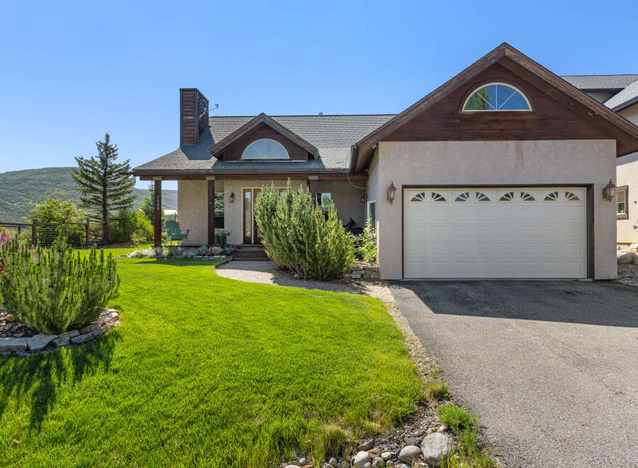 This stunning property boasts a beautiful exterior with a well-manicured lawn and lush landscaping.