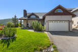 This stunning property boasts a beautiful exterior with a well-manicured lawn and lush landscaping.