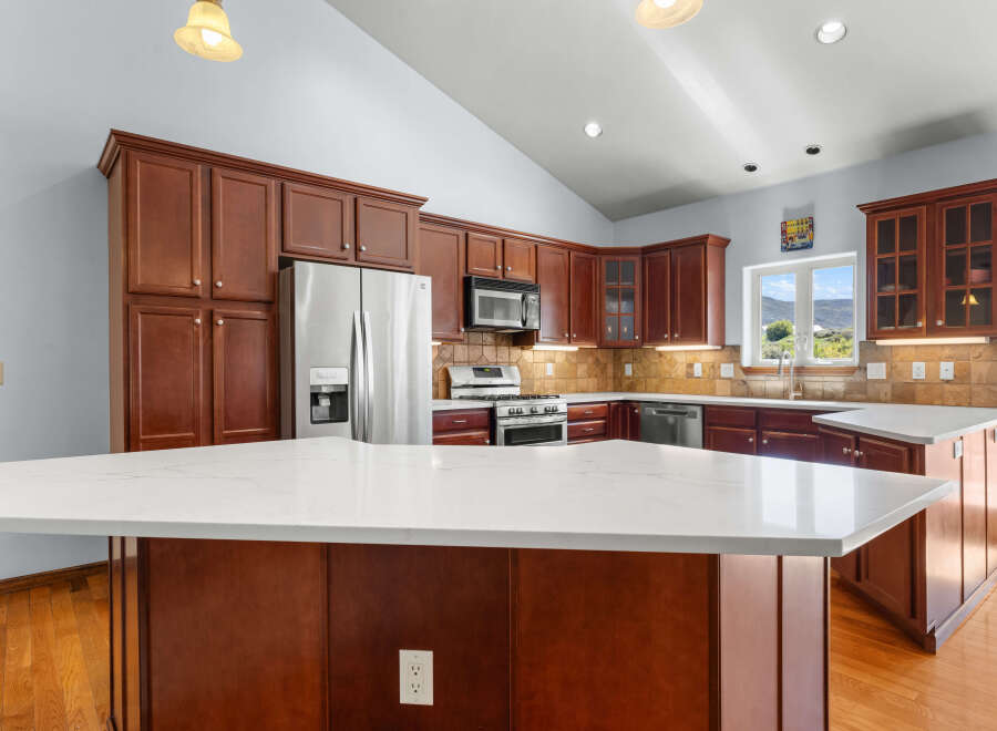 This stunning kitchen boasts rich, dark wood cabinetry and a spacious layout, perfect for both cooking and entertaining.
