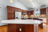 This stunning kitchen boasts rich, dark wood cabinetry and a spacious layout, perfect for both cooking and entertaining.