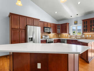 This stunning kitchen boasts rich, dark wood cabinetry and a spacious layout, perfect for both cooking and entertaining.
