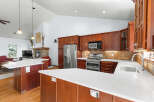 This stunning kitchen boasts a modern design with sleek countertops and rich wood cabinetry.
