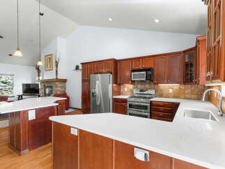 This stunning kitchen boasts a modern design with sleek countertops and rich wood cabinetry.