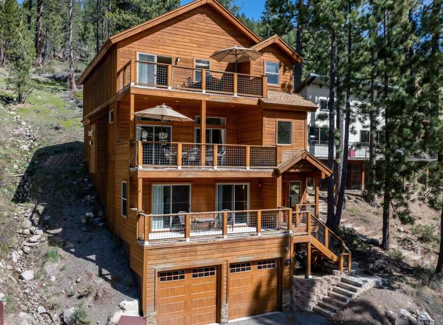 This stunning multi-story home offers a luxurious living experience with its expansive balconies and inviting outdoor spaces.