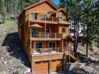 This stunning multi-story home offers a luxurious living experience with its expansive balconies and inviting outdoor spaces.