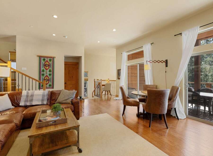Step into luxury with this stunning property, featuring a spacious living area with a cozy leather sofa and a stylish coffee table.