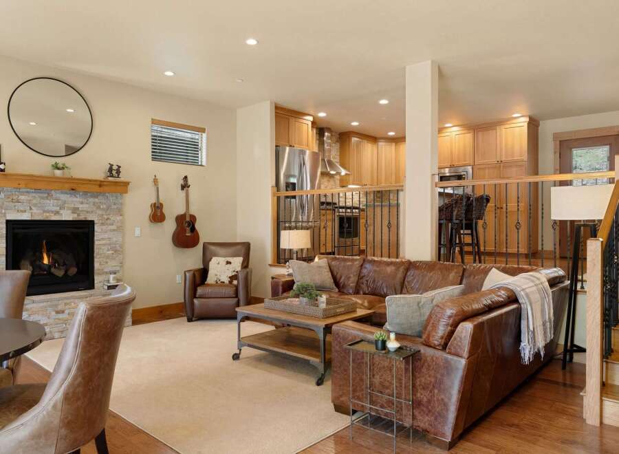 This stunning property boasts a cozy living room with a fireplace, perfect for relaxing evenings.