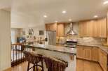 This stunning kitchen boasts a modern design with a beautiful stone backsplash and stainless steel appliances.