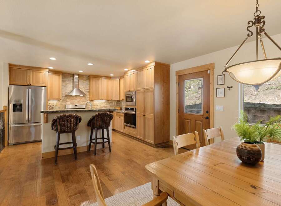 Step into this stunning kitchen, featuring beautiful wooden cabinetry and a stylish breakfast bar.