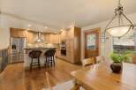 Step into this stunning kitchen, featuring beautiful wooden cabinetry and a stylish breakfast bar.