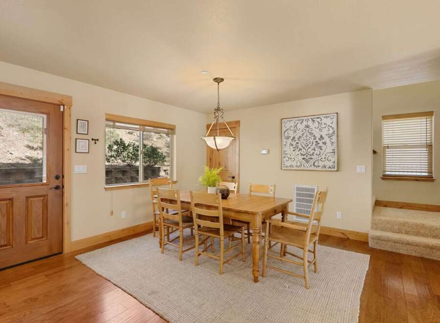 This inviting dining room features a warm, wooden table and chairs, perfect for family gatherings.