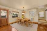 This inviting dining room features a warm, wooden table and chairs, perfect for family gatherings.
