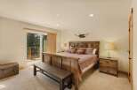 This stunning bedroom boasts a rustic charm with its wooden furniture and warm color palette.