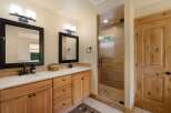 This stunning bathroom features a modern design with natural wood cabinetry and sleek black fixtures.