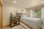 This cozy bedroom features a rustic wooden headboard and a charming heart-shaped wall decor, creating a warm and inviting atmosphere.