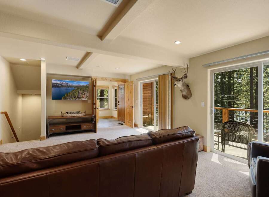 This stunning property boasts a cozy living room with a luxurious leather sofa, perfect for relaxing.