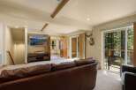 This stunning property boasts a cozy living room with a luxurious leather sofa, perfect for relaxing.