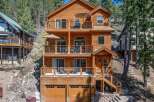 This stunning wooden cabin offers a serene retreat with multiple levels of balconies, perfect for enjoying the surrounding natural beauty.