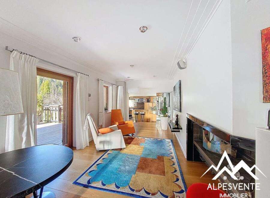 Discover the charm of this stunning property, featuring a bright and airy living space with a modern fireplace.