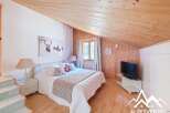 This charming bedroom features a cozy wooden ceiling and walls, creating a warm and inviting atmosphere.