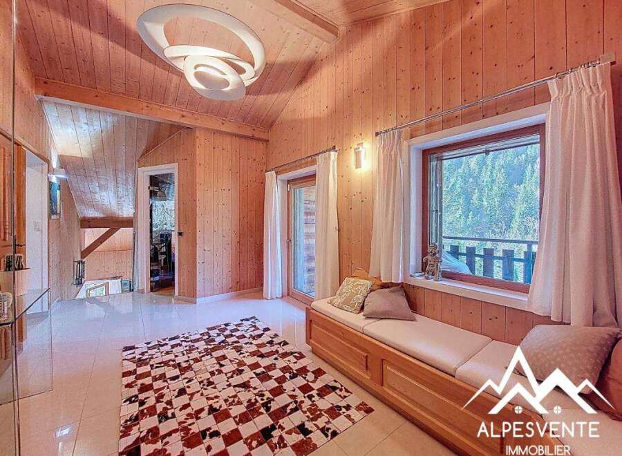 Discover the charm of this stunning property, featuring a warm and inviting interior with wooden paneling throughout.