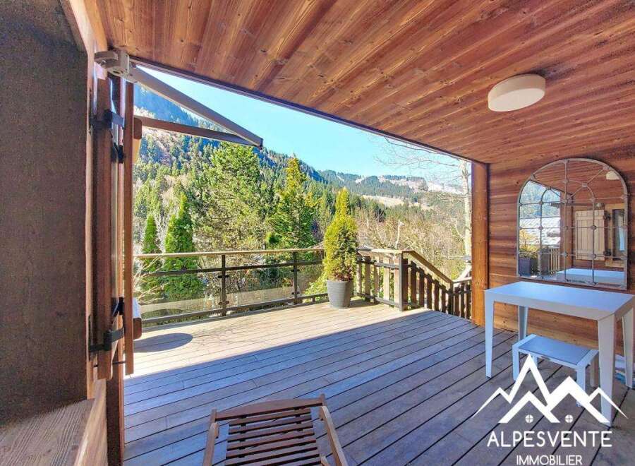 Discover the charm of this stunning property, featuring a spacious wooden deck perfect for enjoying the breathtaking mountain views.