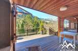 Discover the charm of this stunning property, featuring a spacious wooden deck perfect for enjoying the breathtaking mountain views.