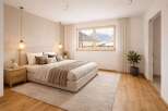 This stunning bedroom offers a serene retreat with its neutral color palette and natural light.