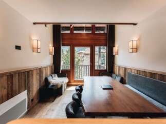 This stunning dining area features a large wooden table, perfect for gatherings.