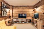 This cozy living space features a stunning wooden wall and built-in bookshelves, creating a warm and inviting atmosphere.