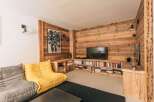 This cozy living space features a stunning wooden accent wall, creating a warm and inviting atmosphere.