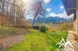 Discover your dream home with breathtaking mountain views! This property boasts a lush green lawn and a charming outdoor space, perfect for relaxation and entertaining.