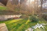 Discover the charm of this property, featuring a lush green lawn and a serene outdoor space.