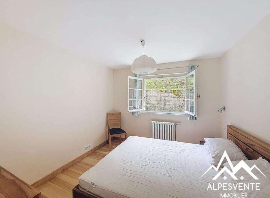 Discover this charming bedroom featuring a cozy bed and a bright window.