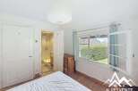 Discover this charming property featuring a bright bedroom with a large window offering stunning views.