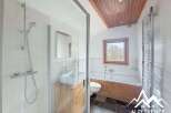 Discover this charming bathroom featuring a modern shower and a relaxing bathtub.