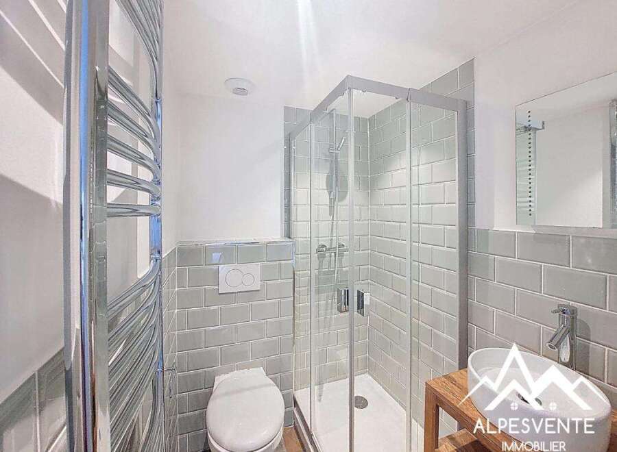 This modern bathroom features a sleek glass shower, perfect for a refreshing start to your day.