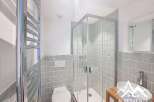 This modern bathroom features a sleek glass shower, perfect for a refreshing start to your day.